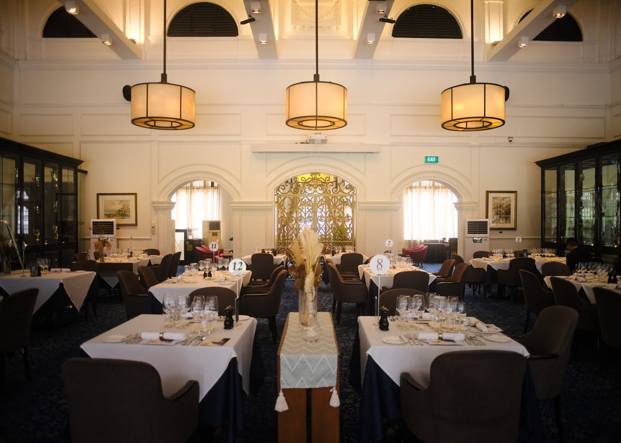 gallery-02 Luxurious restaurant setting with elegant chandeliers and table settings, perfect for upscale dining experiences.